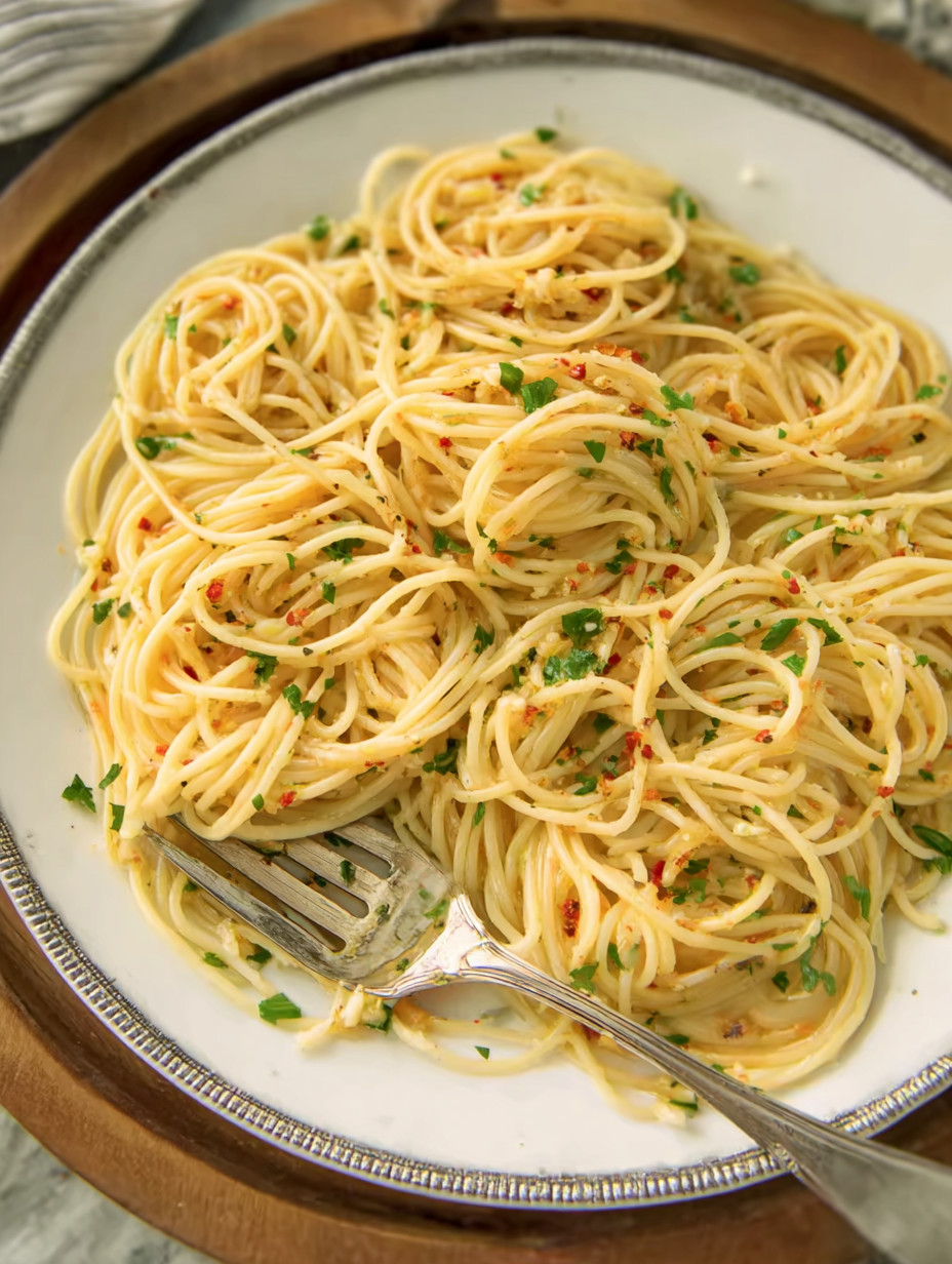 A plate of spaghetti with red peppers.
