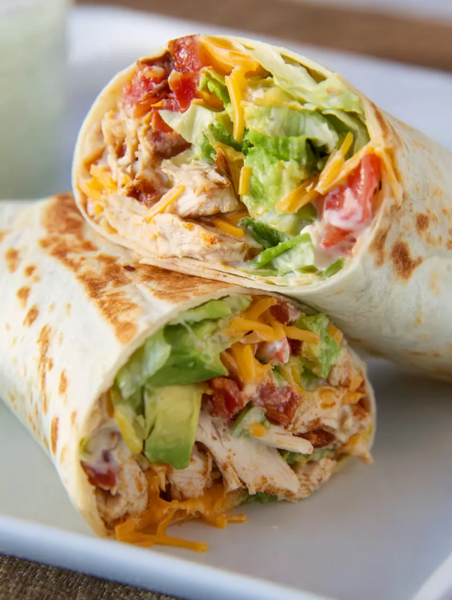Two wraps with lettuce and cheese.
