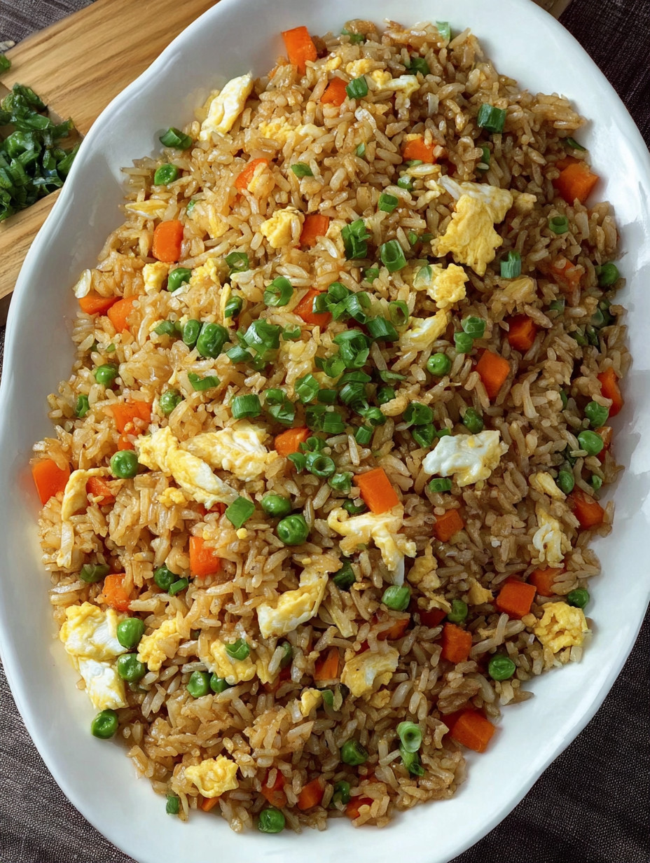 A plate of rice with peas and carrots.