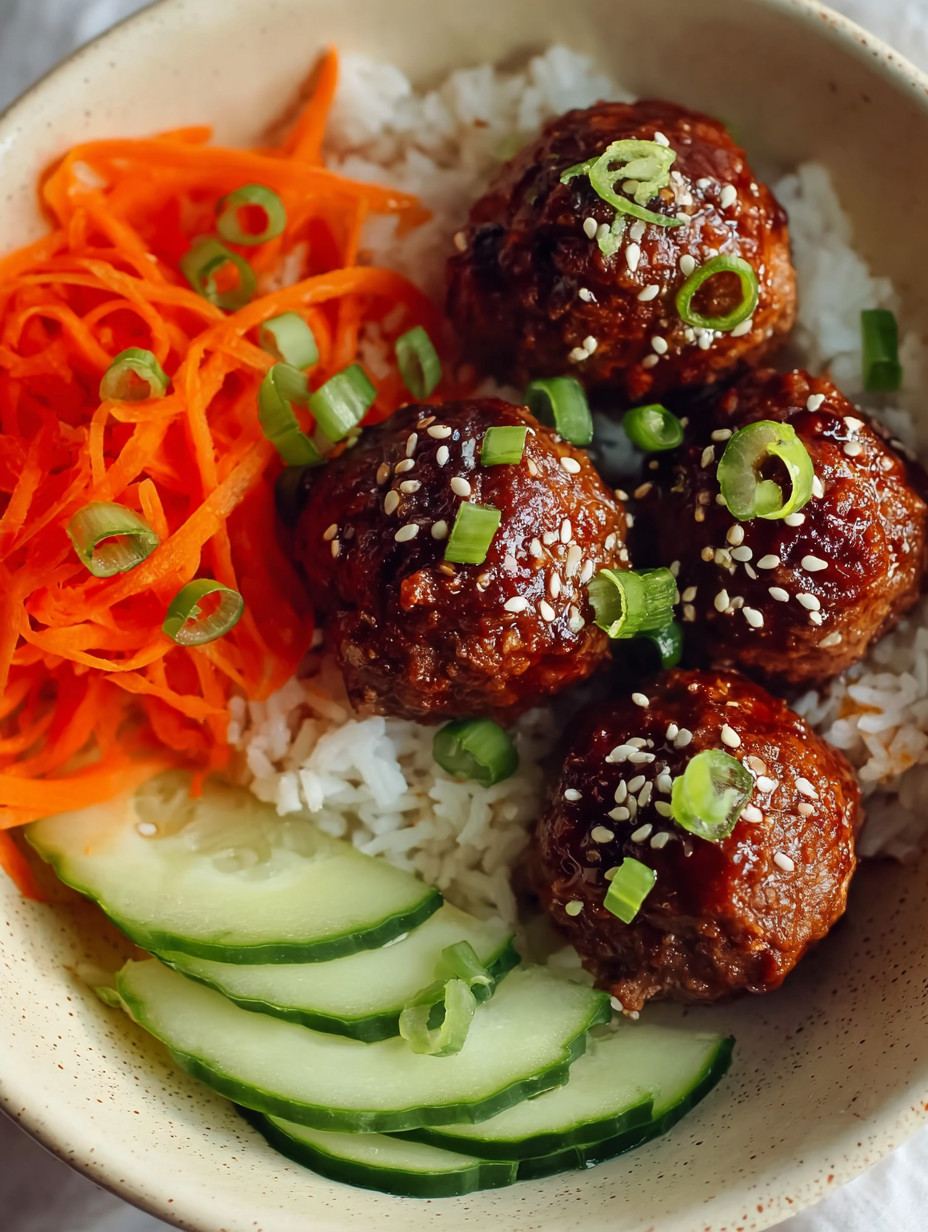 A bowl of food with meatballs and rice.