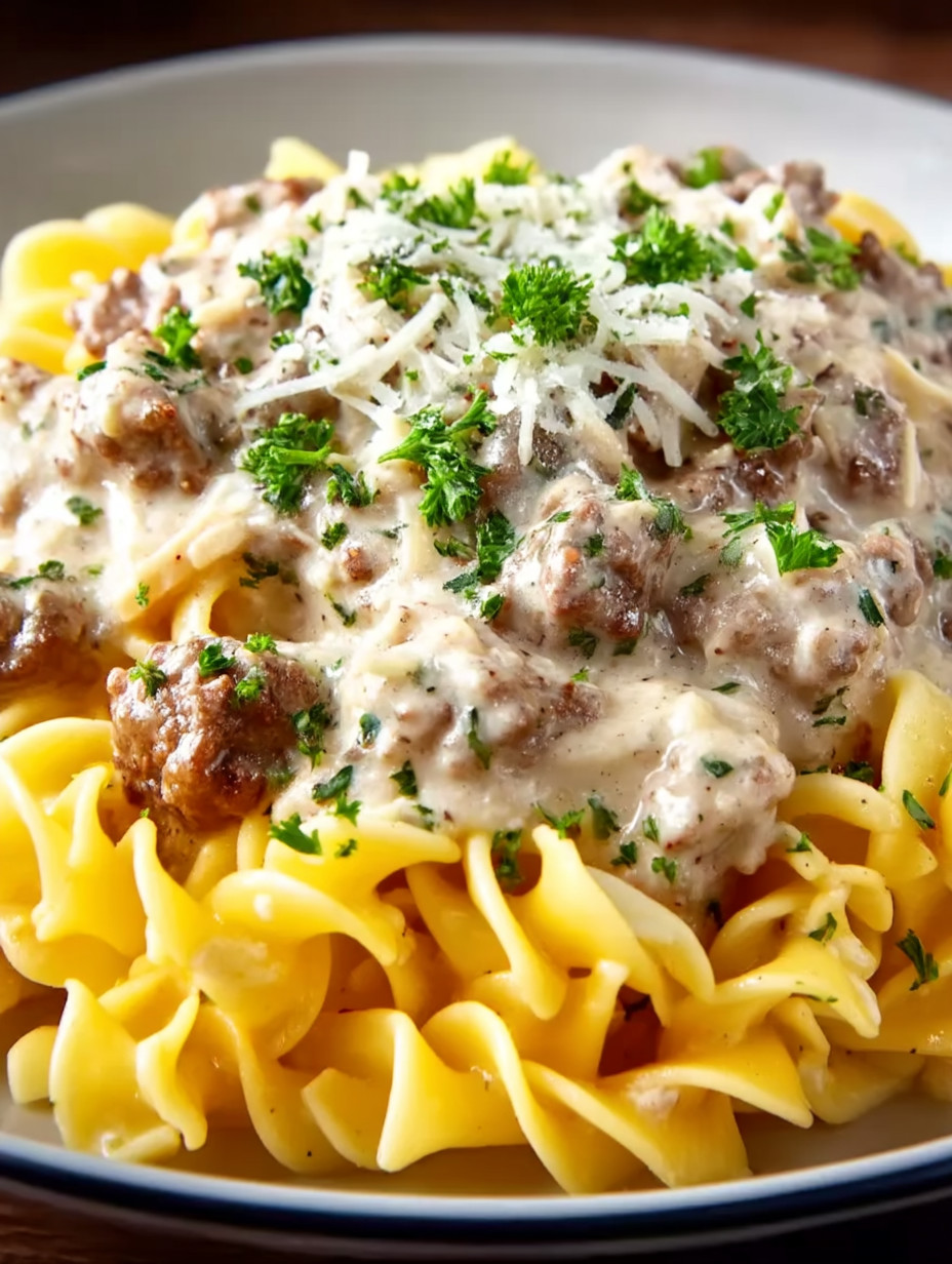 A plate of pasta with meat and cheese.