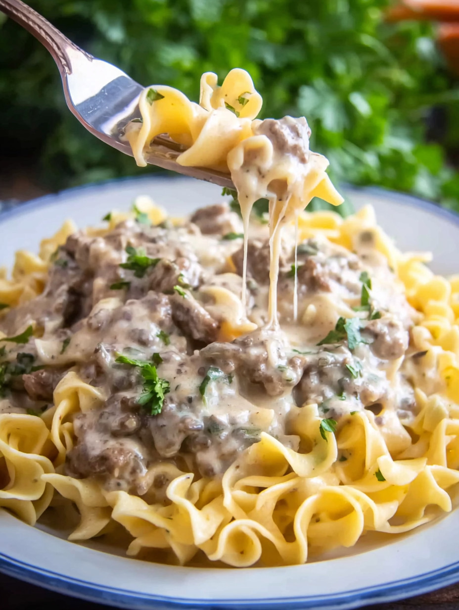 A fork is being used to eat pasta.