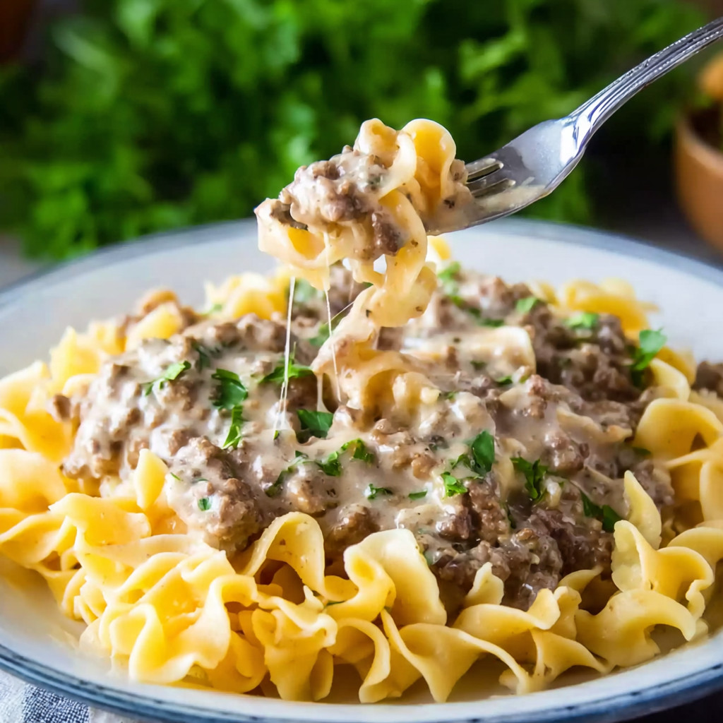 A fork is in a bowl of pasta.