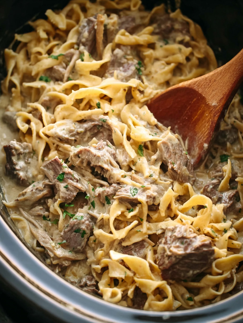 A bowl of pasta with meat and cheese.