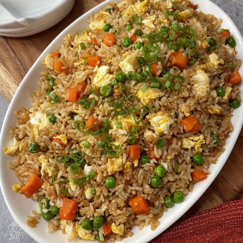 A white bowl filled with rice and peas.